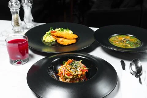 Set dinner of three courses. Chef's specialty presented in restaurant on serv Stock Photos