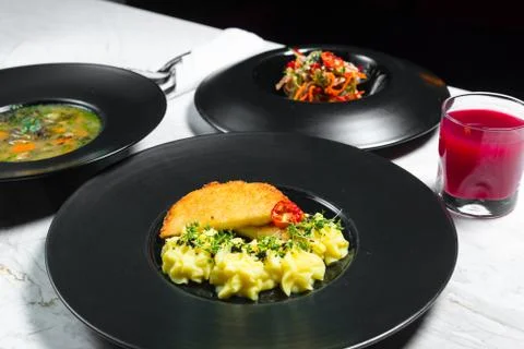 Set dinner of three courses. Chef's specialty presented in restaurant on serv Stock Photos