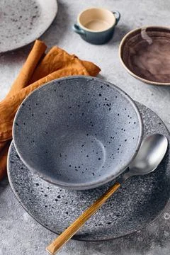 Set of dinnerware with a spoon and a napkin. The table setting is simple and  Stock Photos