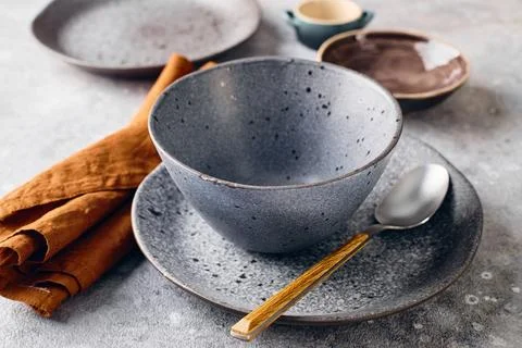 Set of dinnerware with a spoon and a napkin. The table setting is simple an.. Stock Photos