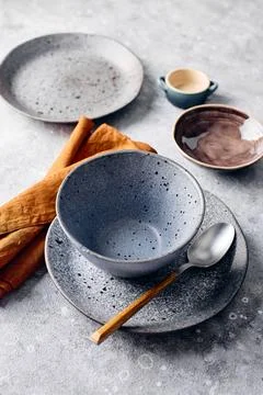 Set of dinnerware with a spoon and a napkin. The table setting is simple and  Stock Photos
