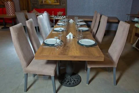 Set of a dish with spoon, fork and knife on wooden table. Empty Table setting Stock Photos