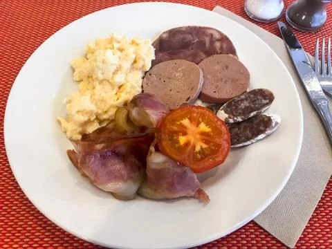Set of dishes on breakfast table. Scrambled eggs, omelette, pate, croissants, Stock Photos