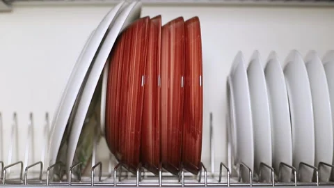 A set of dishes is dried and placed on a metal stand in the kitchen cabinet Stock Footage 169364923