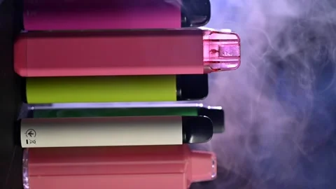 A set of disposable electronic cigarettes rotate on a black background 스톡 동영상 282390350