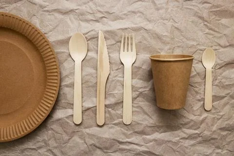 A set of disposable tableware on a paper background Stock Photos