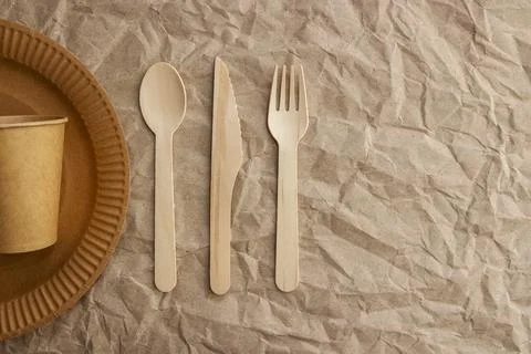 A set of disposable tableware on a paper background Stock Photos