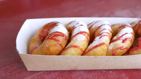 Set of donuts with powder sugar and strawberry topping in paper box Stock-Footage 154267673