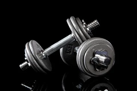 Set of dumbells on black Stock Photos