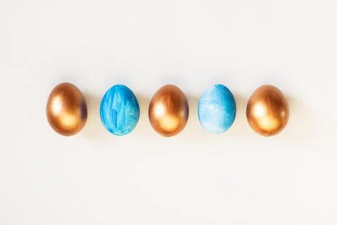Set of Easter blue and golden color eggs isolated on white background. Stylish Stock Photos