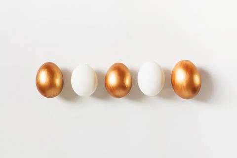 Set of Easter golden color eggs isolated on white background. Stylish trendy Stock Photos