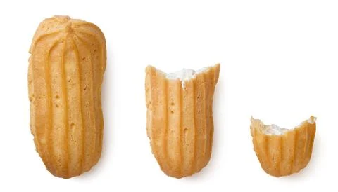 Set of eclairs and two pieces close-up on a white. Top view Stock Photos