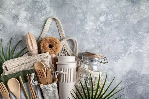 Set of eco friendly  kitchen accessories in a string bag. Stock Photos