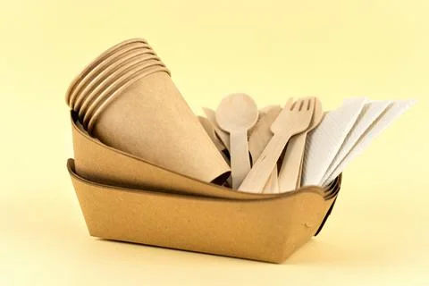 Set of eco tableware on a beige background. Stock Photos