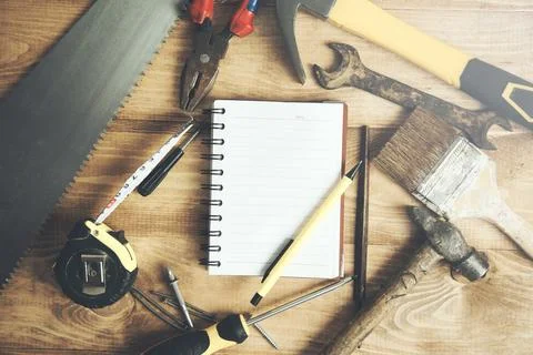 Set of electrical tools, white helmet and notepad on metallic background Stock Photos