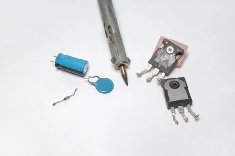 Set of electronics: transistors, capacitors, diode and soldering tip Stock Photos