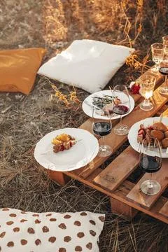 Set of elegant glassware placed on plank wooden table with floral arrangement on Foto stock