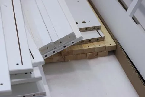 A set of elements for assembling an ottoman. Spread out on the floor. Close-u Stock Photos