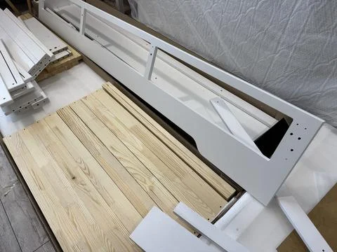 A set of elements for assembling an ottoman. Spread out on the floor. Stock Photos