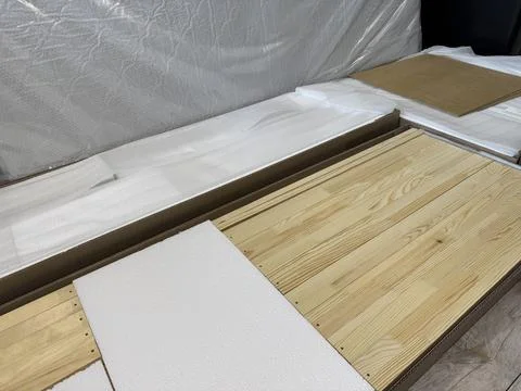 A set of elements for assembling an ottoman. Wooden slats in packaging, lying Foto stock