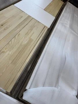 A set of elements for assembling an ottoman. Wooden slats in packaging, lying Stock Photos