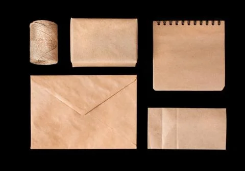 Set of elements from brown kraft paper. Isolated on black background, top vie Stock Photos