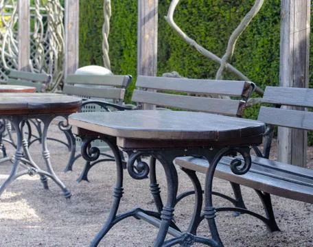 A set of empty benches and tables outside Stock Photos