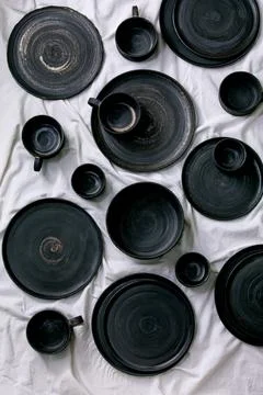 Set of empty black handcrafted ceramic plates 스톡 사진