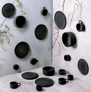 Set of empty black handcrafted ceramic plates Stock Photos