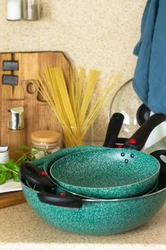 Set of empty ceramic coated dishes on a stone kitchen worktop surrounded. Stock-Fotos