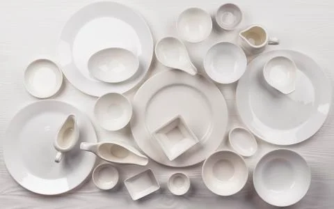 Set of empty dishware on white background with copy space Foto stock