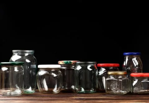 Set of empty glass jars for conservation, on black  background Stock Photos