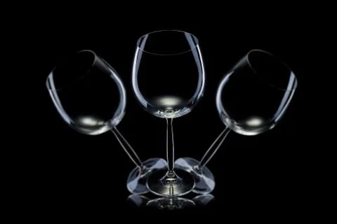 Set of empty glasses for red wine in a row isolated on black background. Stock Photos