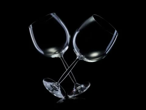 Set of empty glasses for red wine in a row isolated on black background. Stock Photos