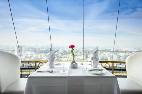 Set of empty glasses in a restaurant and view city Stock Photos