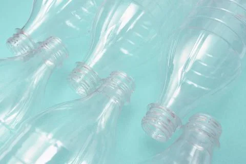 Set of empty plastic bottles on a turquoise background. The problem of plastic Stock Photos