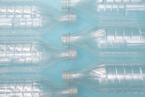 Set of empty used plastic bottles on a blue background. The problem of plastic Stock Photos