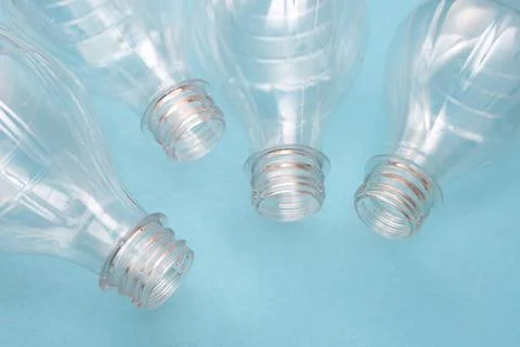 Set of empty used plastic bottles on a blue background. The problem of plastic Stock Photos