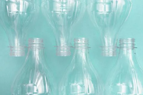 Set of empty used plastic bottles on a turquoise background. The problem of Stock Photos