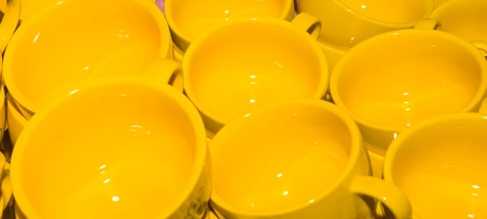 Set of empty yellow coffee cups on the bar Stock Photos
