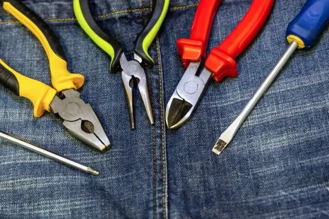 Set engineering pair of pliers screwdriver close up hand tool design on dark Stock Photos