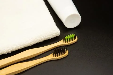 Set of environmentally friendly toothbrushes and toothpaste on a black Stock Photos