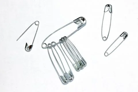 A set of fabric pins on a white background. Stock Photos
