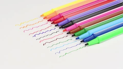 A set of felt-tip pens in different colors with lines on paper Stock Footage 237505323