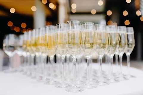 Set of filled champagne glasses arranged in a triangle Stock Photos