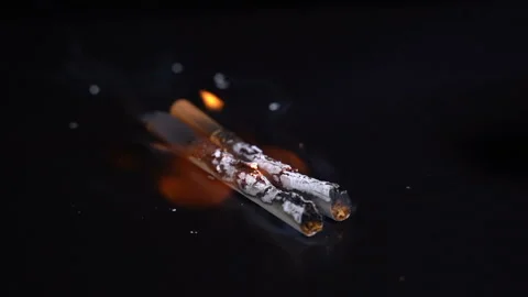 Set fire to a cigarette on a black background Видео 119280181