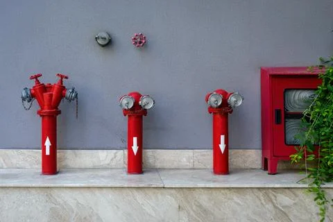 Set fire hydrants by the wall Stock Photos