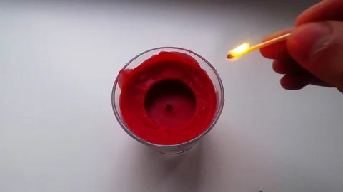 Set on fire with matches on red candle Stock Footage 85897753