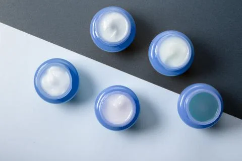 A set of five blue jars with moisturizers for day and night use. Men's cosmetics Stock Photos