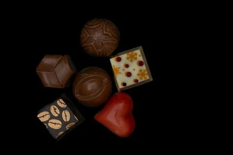 Set of five chocolate candy on black table Stock Photos